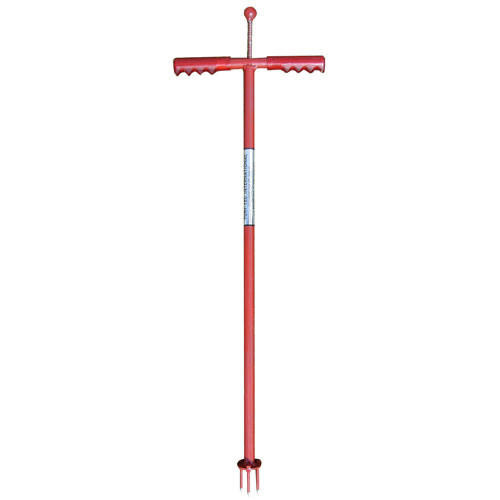 A person using Turf-Tec Weed Away Weed Removal Tool to pull weeds from the garden