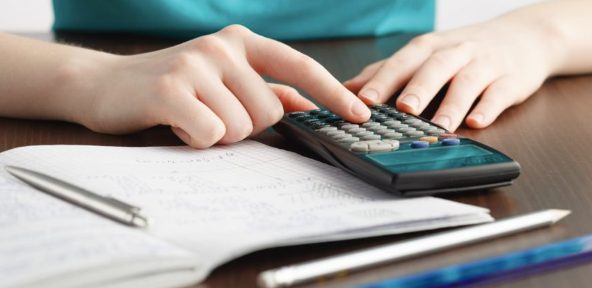 A person double-checking their math on a calculator
