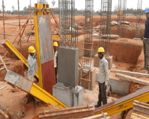 A technician removing formwork from a concrete structure